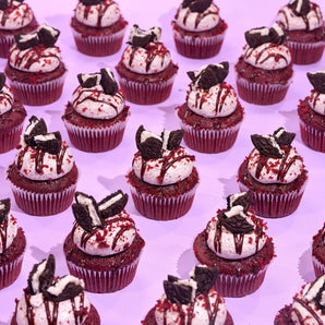 Vegan Red Velvet Volcano Cupcakes by Crumbs & Doilies with Oreo icing, ganache drizzle, and red velvet crumbs.